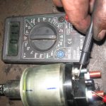 The fuel pump is checked using a multimeter