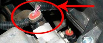 Where is the camshaft sensor located on the VAZ-2114